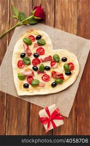 flat lay heart shaped pizza wooden table