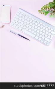 Flat lay home office workspace. Flat lay home office workspace - white modern keyboard on pink background