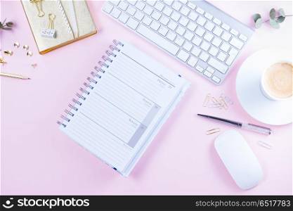 Flat lay home office workspace. Flat lay home office workspace - white modern keyboard with notebook on pink background