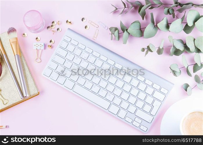 Flat lay home office workspace. Flat lay home office workspace - white modern keyboard with female accessories on pink background