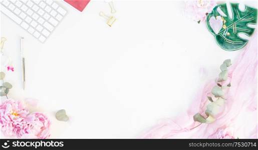 Flat lay home office workspace frame - modern keyboard with female accessories and peony flowers, copy space on white background banner. Top view home office workspace