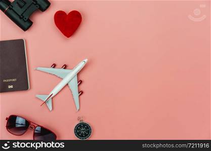 Flat lay image of accessory clothing man or women to plan travel in holiday background concept.Airplane & passport with many item in vacation season.Table top view several object on pink paper.