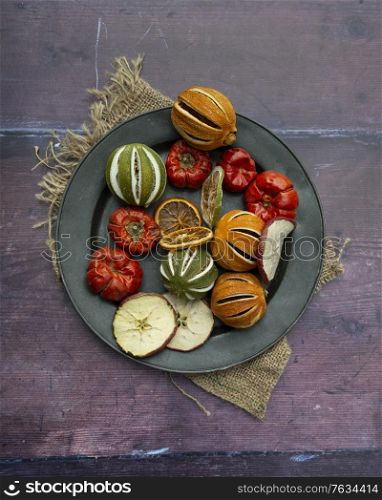 Flat lay image of dried seasonal Winter fruit on textured rough background