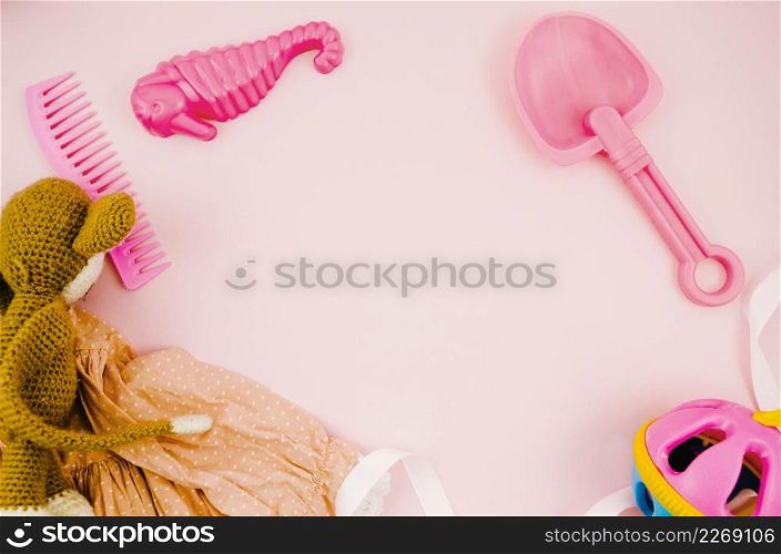 flat lay kids toys with pink background