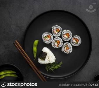 flat lay maki sushi with rice chopsticks