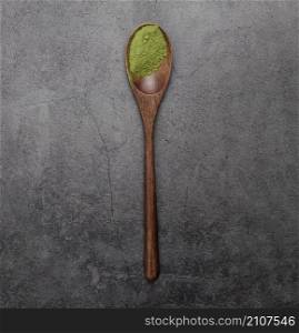 flat lay matcha tea powder wooden spoon