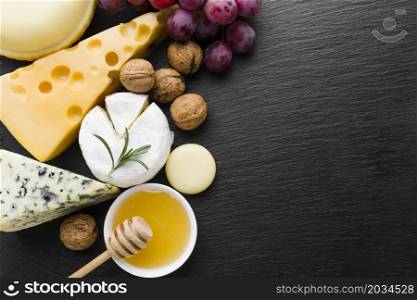 flat lay mix cheese walnuts honey with copy space