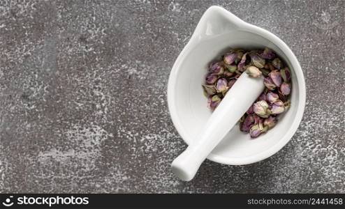 flat lay mortar pestle with rose buds copy space