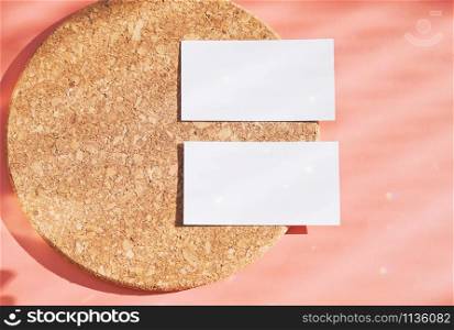 Flat lay of branding identity business name card on wood board and orange background, light and shadow shape with sparkle effect, minimal design