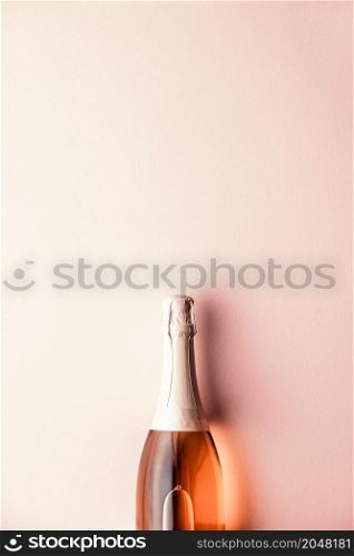 Flat lay of Celebration. Champagne bottle on pink background, top view. Flat lay of Celebration. Champagne bottle on pink background