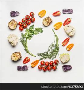 Flat lay of colorful salad vegetables ingredients with seasoning on white background, top view, frame. Healthy clean eating layout, vegetarian food and diet nutrition concept