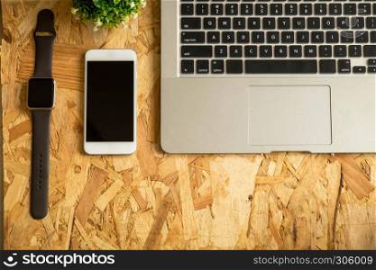 Flat lay of laptop on wood table. Background