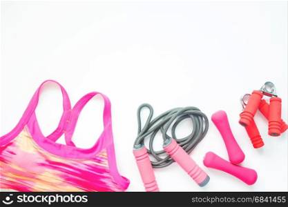 Flat lay of sport bra and sport equipments in pink color, healthy lifestyle concept with copy space
