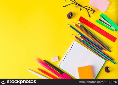 Flat lay of stationery on a yellow background. Back to school concept. Place for text.. Flat lay of stationery on yellow background. Back to school concept. Place for text.