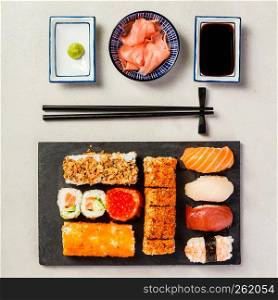 Flat-lay of sushi set on grey concrete background. Flat-lay of sushi set on grey concrete background, square composition