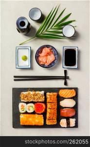 Flat-lay of sushi set on grey concrete background. Flat-lay of sushi set on grey concrete background, vertical composition