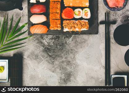 Flat-lay of sushi set on grey concrete background. Flat-lay of sushi set on grey concrete background, vertical composition