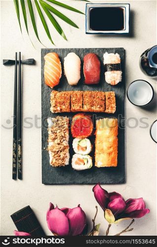 Flat-lay of sushi set on grey concrete background, flat lay. Flat-lay of sushi set on grey concrete background
