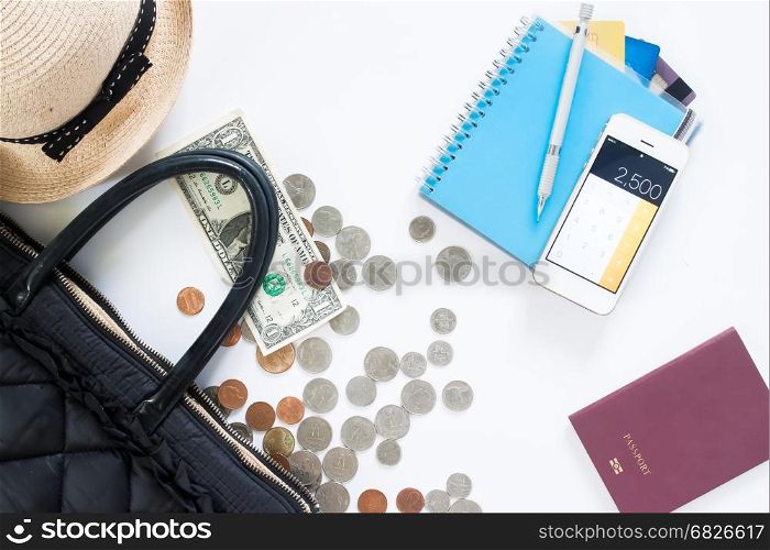 Flat lay of travel concept with hand bag, money, credit card, mobile phone and passport on white background