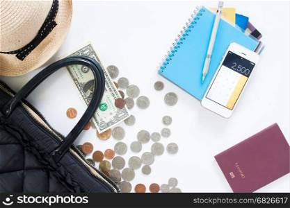 Flat lay of travel concept with hand bag, money, credit card, mobile phone and passport on white background