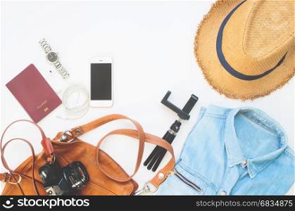 Flat lay of Treveler's items, Essential vacation accessories of young smart woman, Travel concept on white background