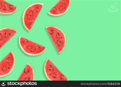 Flat lay of watermelon half slices on mint background. Watermelon pattern. Summer fruit. Creative Minimal summer pop art concept. Copy space. Flat lay of watermelon half slices on mint background. Watermelon pattern.