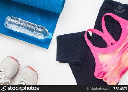 Flat lay of yoga and sport equipments with bottle of water on white background, Healthy lifestyle concept