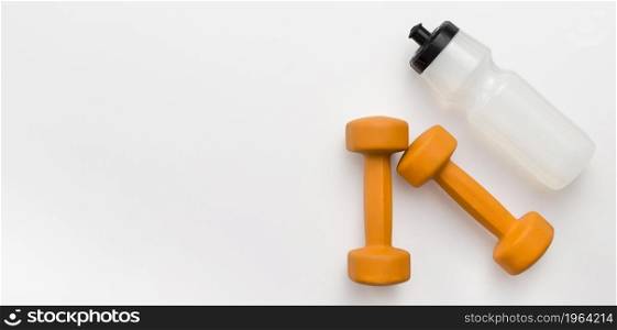 flat lay orange weights with water bottle copy space. High resolution photo. flat lay orange weights with water bottle copy space. High quality photo