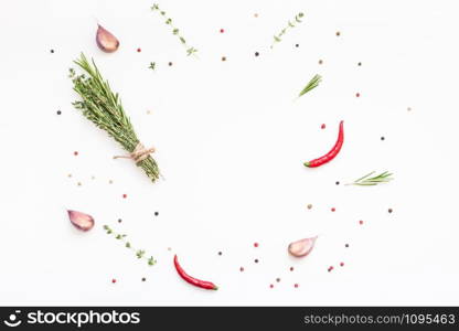 Flat lay overhead top view of greens herbs and spices on white background with copy space. Menu frame design food pattern background with cooking ingredients