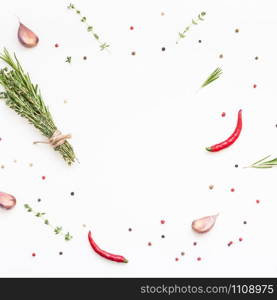 Flat lay overhead top view of greens herbs and spices on white background with copy space. Menu frame design food pattern background with cooking ingredients