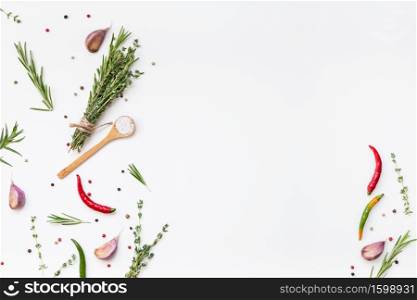Flat lay overhead top view of greens herbs and spices on white background with copy space. Menu frame design food pattern background with cooking ingredients