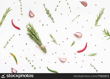 Flat lay overhead top view of greens herbs and spices on white background with copy space. Menu frame design food pattern background with cooking ingredients