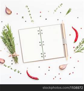 Flat lay overhead view blank notebook pages mockup text space invitation card on white background with greens herbs and spices. Menu or recipe book or food blog design with cooking ingredients