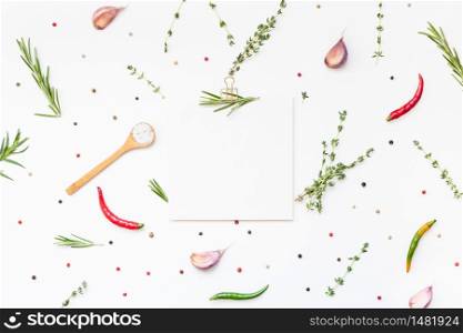 Flat lay overhead view blank recipe paper page with clip mockup text space invitation card on white background with greens herbs and spices. Menu recipe book food blog design with cooking ingredients
