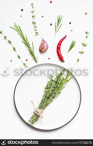 Flat lay overhead view empty plate mockup blank text space invitation card on white background with greens herbs and spices. Menu design food background with cooking ingredients