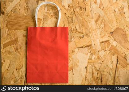 Flat lay paper shopping bag on a wooden background