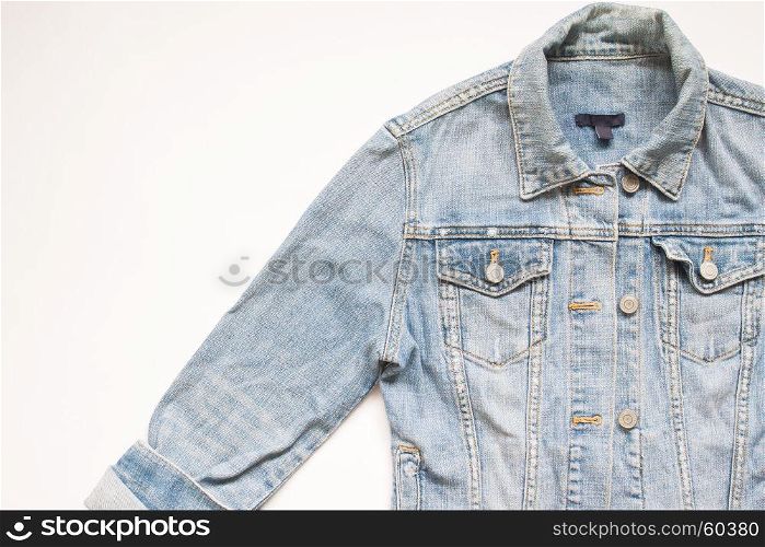 Flat lay part of jeans jacket on white background with copy space