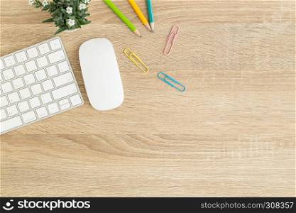 Flat lay photo of office desk with mouse and keyboard ,Top view workpace on wood table and copy space
