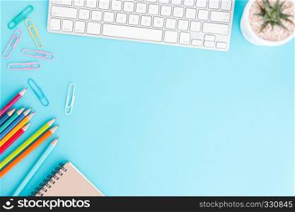 Flat lay photo of office desk with pencil and keyboard ,Top view workpace on blue background and copy space