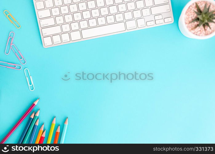 Flat lay photo of office desk with pencil and keyboard ,Top view workpace on blue background and copy space