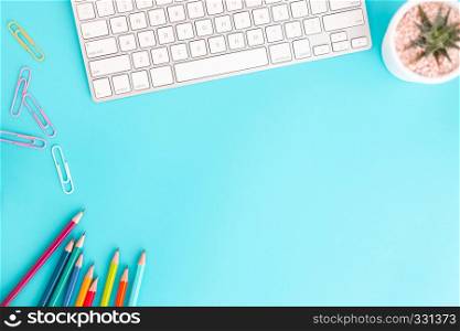 Flat lay photo of office desk with pencil and keyboard ,Top view workpace on blue background and copy space