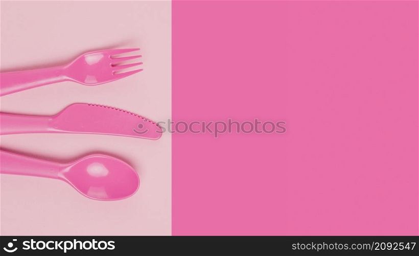 flat lay plastic pink cutlery baby shower