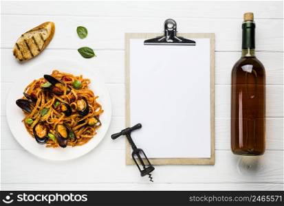 flat lay plate mussels pasta wine with clipboard