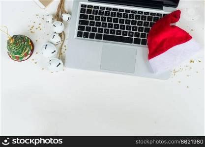 Flat lay scene with office table desk. Workspace with laptop and christmas decorations on white background. Christmas mock up