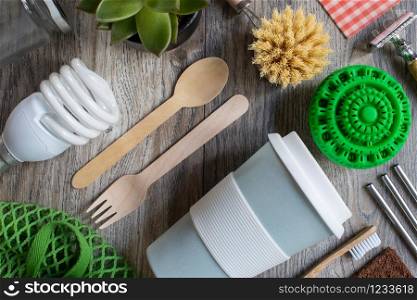 Flat Lay Shot Of Plastic Free Eco Products With Reusable Or Sustainable Zero Waste Products On Wooden Background With Metal Staws Wooden Cutlery Paper Bag Glass Jar Wax Wrapping Paper