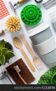 Flat Lay Shot Of Plastic Free Eco Products With Reusable Or Sustainable Zero Waste Products On Wooden Background With Metal Staws Wooden Cutlery Paper Bag Glass Jar Wax Wrapping Paper