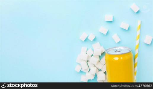flat lay soft drink can with sugar cubes straw