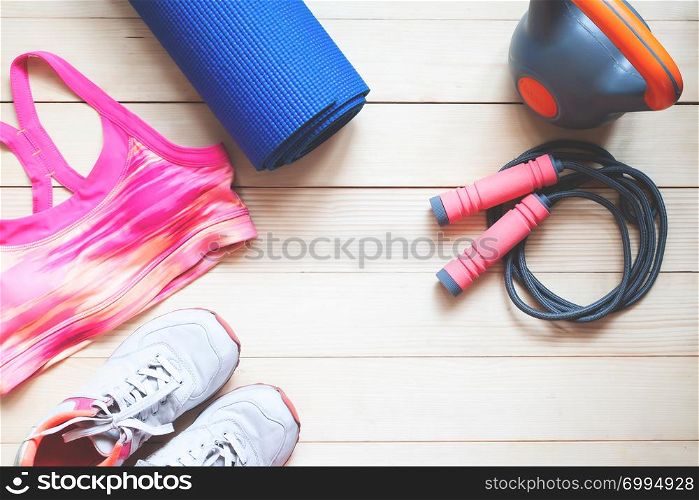 Flat lay sport and fitness items on wooden background. Healthy and Diet concept