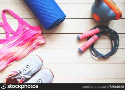 Flat lay sport and fitness items on wooden background. Healthy and Diet concept