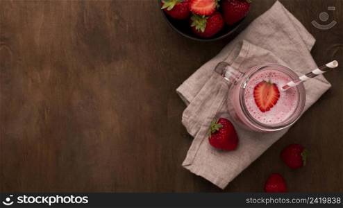 flat lay strawberry milkshake with straw copy space